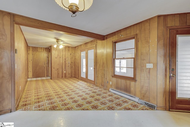 entrance foyer with beam ceiling, wooden walls, and tile patterned floors