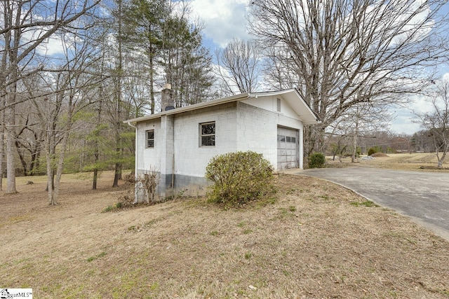 garage featuring concrete driveway