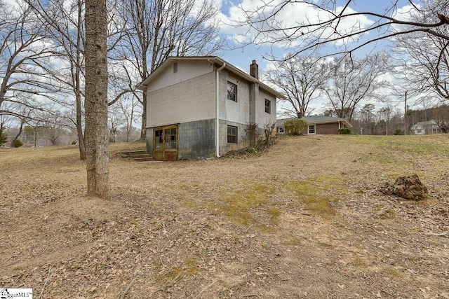 view of side of property with a chimney