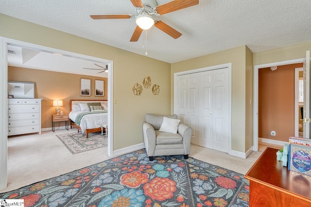 living area featuring a textured ceiling, baseboards, and carpet flooring