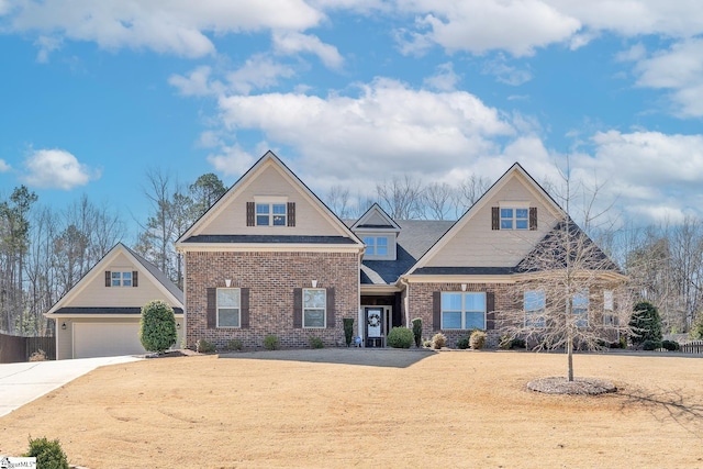 view of front of property with a garage, driveway, and brick siding