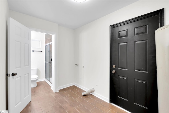 foyer entrance featuring baseboards and wood finish floors