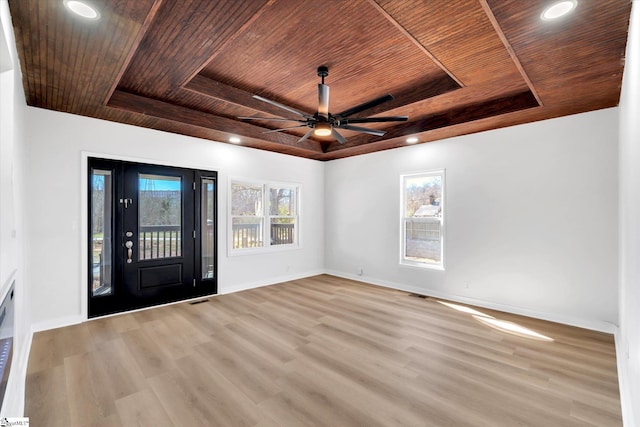 entryway featuring a tray ceiling, wooden ceiling, and baseboards