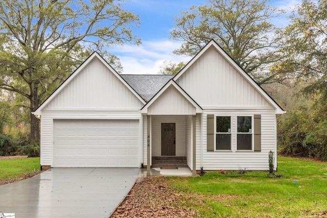 view of front of property featuring entry steps, a garage, a shingled roof, driveway, and a front lawn