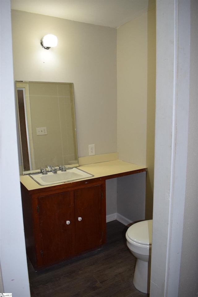 bathroom featuring vanity, toilet, and wood finished floors