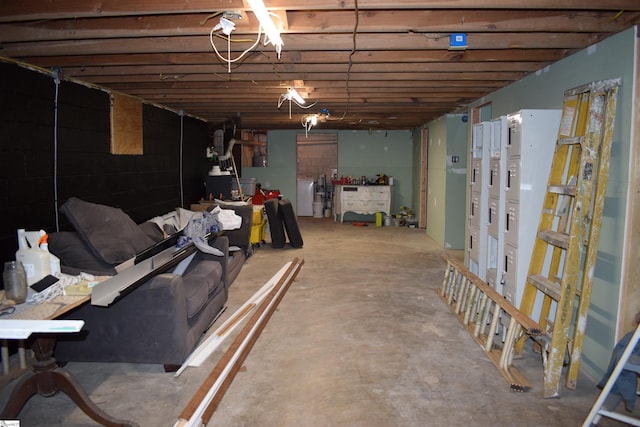 unfinished below grade area with washing machine and clothes dryer