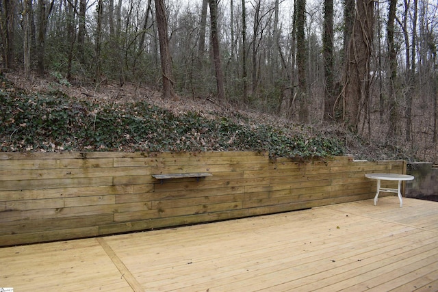 wooden terrace featuring a forest view