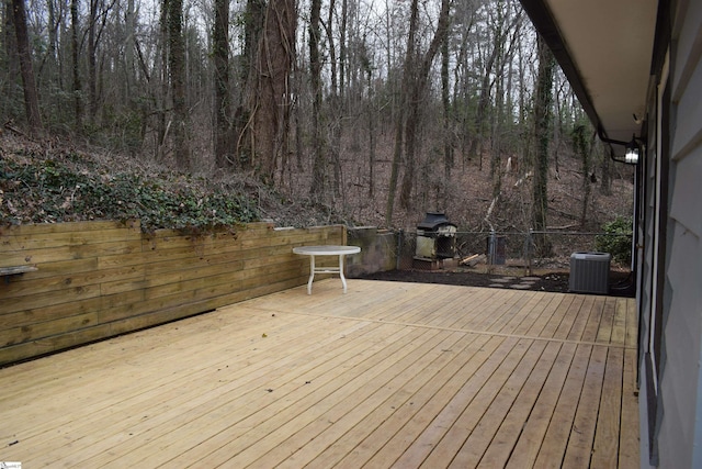 wooden terrace with central AC unit and area for grilling