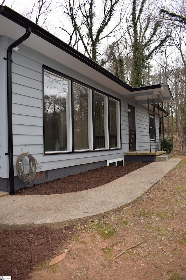 view of side of property featuring crawl space