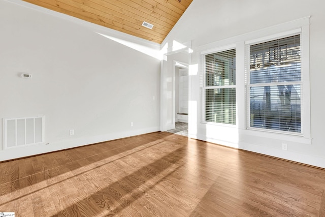 spare room with wood ceiling, visible vents, vaulted ceiling, and wood finished floors