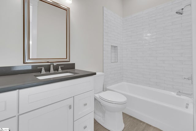 bathroom featuring  shower combination, vanity, toilet, and wood finished floors