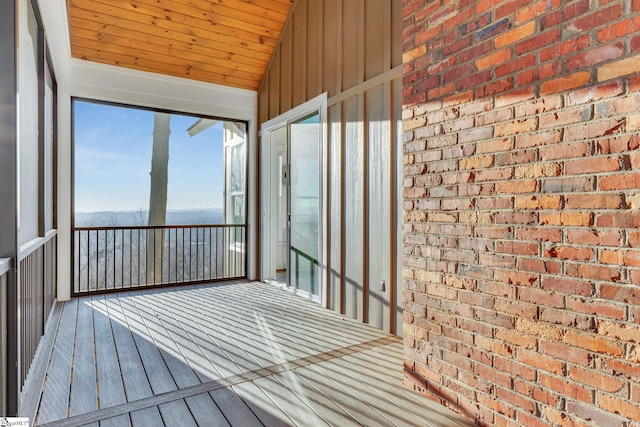 unfurnished sunroom featuring lofted ceiling and wood ceiling