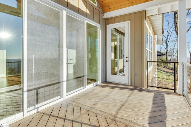 unfurnished sunroom featuring lofted ceiling