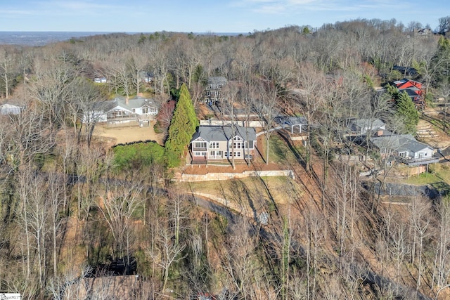 birds eye view of property with a forest view