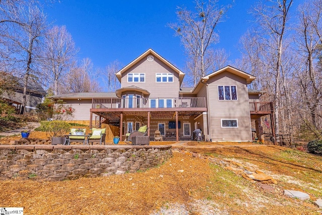 back of house with a deck and a patio area