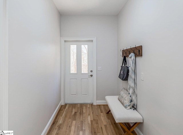 doorway to outside with light wood-style floors and baseboards