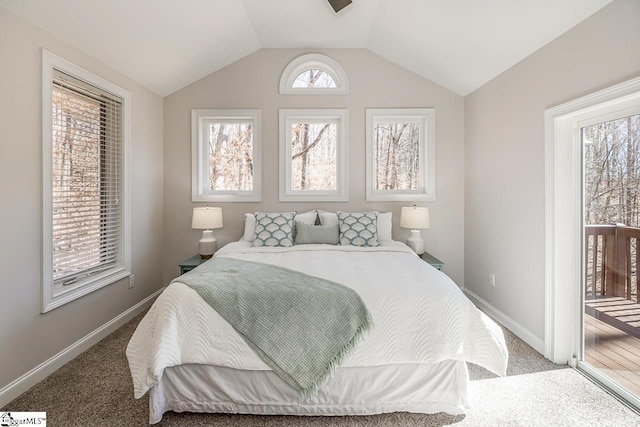 carpeted bedroom featuring vaulted ceiling, multiple windows, baseboards, and access to exterior