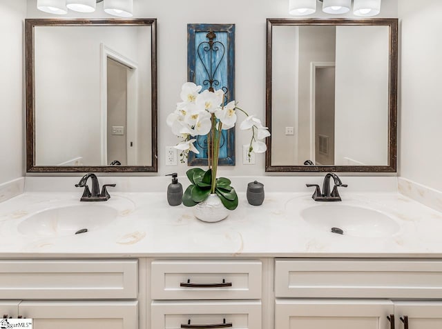 full bathroom featuring visible vents, a sink, and double vanity