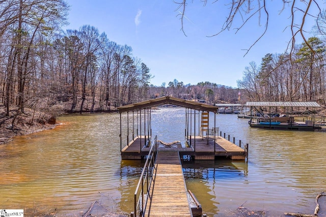 view of dock featuring a water view and a wooded view