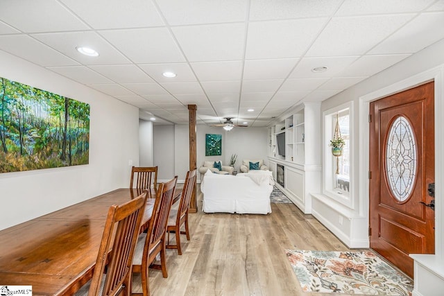 dining room featuring recessed lighting, a drop ceiling, and light wood finished floors