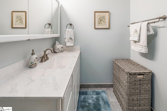 bathroom with vanity and baseboards