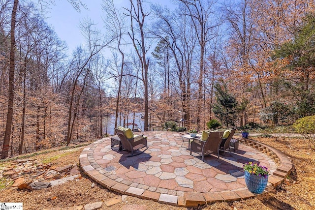 view of patio featuring a forest view