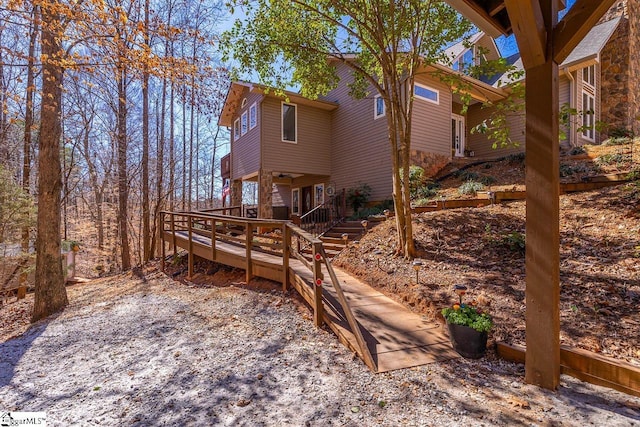 back of house with a wooden deck