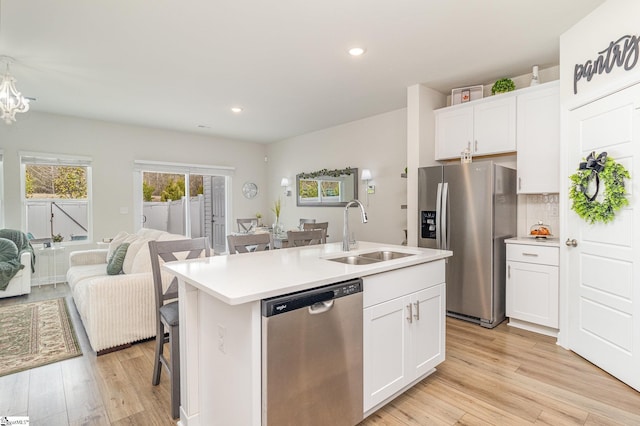107 Tramore Ln, Fountain Inn, SC 29644 - kitchen featuring a kitchen island with sink, appliances with stainless steel finishes, a sink, light wood-style floors, and open floor plan