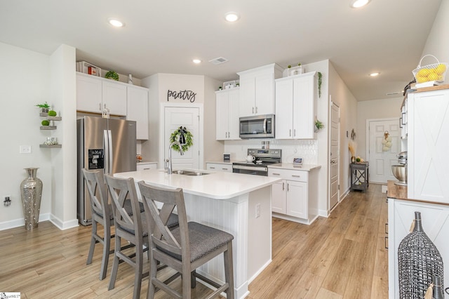 107 Tramore Ln, Fountain Inn, SC 29644 - kitchen with visible vents, appliances with stainless steel finishes, a sink, an island with sink, and a kitchen breakfast bar