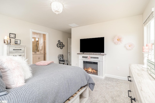 107 Tramore Ln, Fountain Inn, SC 29644 - carpeted bedroom featuring baseboards, a warm lit fireplace, visible vents, and ensuite bath