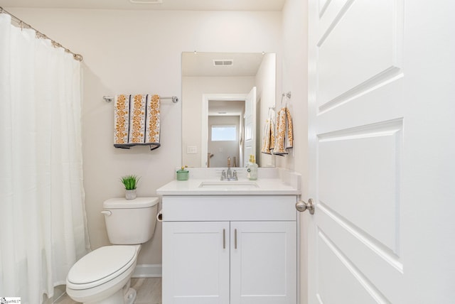 107 Tramore Ln, Fountain Inn, SC 29644 - bathroom with toilet, vanity, baseboards, and visible vents