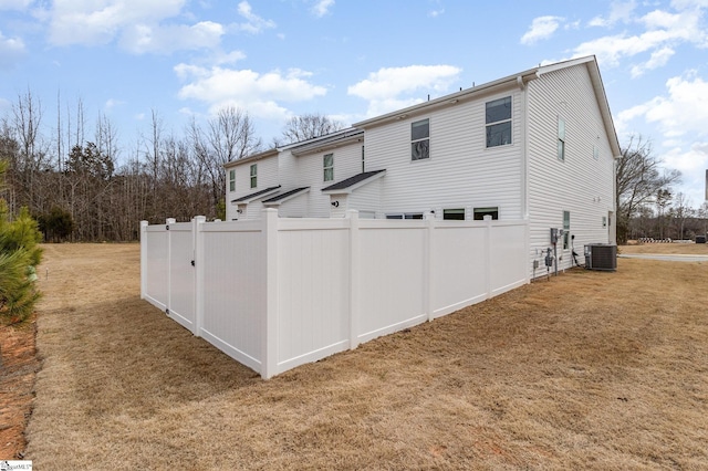 107 Tramore Ln, Fountain Inn, SC 29644 - back of property with a garage, central AC, fence, and a lawn