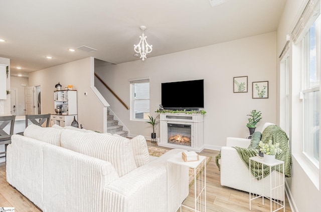 107 Tramore Ln, Fountain Inn, SC 29644 - living area featuring light wood-style flooring, baseboards, stairs, and visible vents