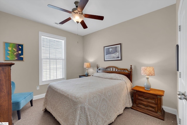 bedroom featuring carpet floors, baseboards, visible vents, and a ceiling fan