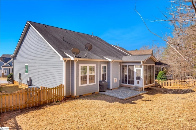 back of property featuring a yard, crawl space, a patio area, and fence