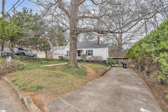 view of front of home with a chimney and a front lawn