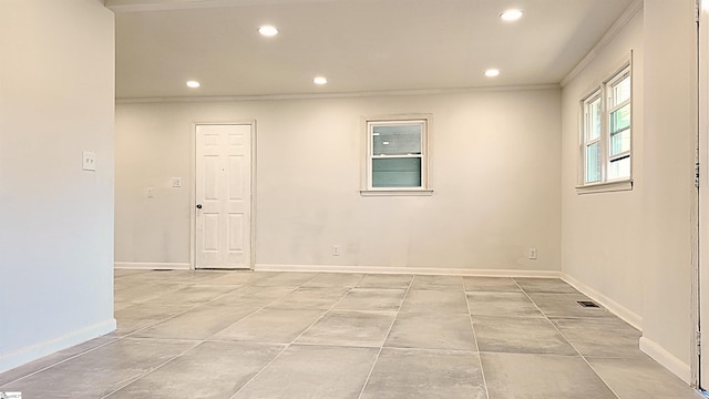 spare room featuring baseboards, crown molding, and recessed lighting