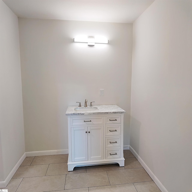 bathroom with tile patterned flooring, vanity, and baseboards