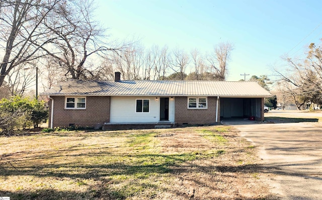 ranch-style home with metal roof, brick siding, concrete driveway, a carport, and a chimney