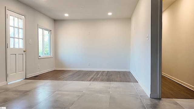 foyer entrance featuring baseboards, a wealth of natural light, and recessed lighting