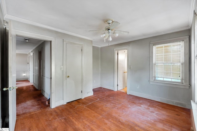 unfurnished bedroom featuring ceiling fan, ornamental molding, wood finished floors, and baseboards