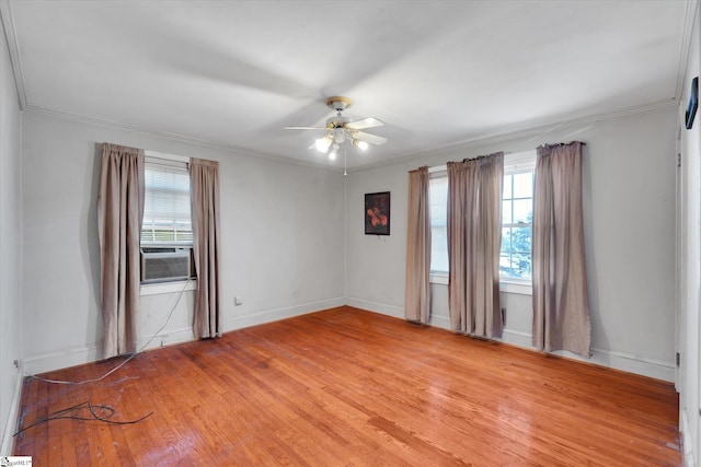 spare room featuring a ceiling fan, cooling unit, ornamental molding, and light wood-style flooring