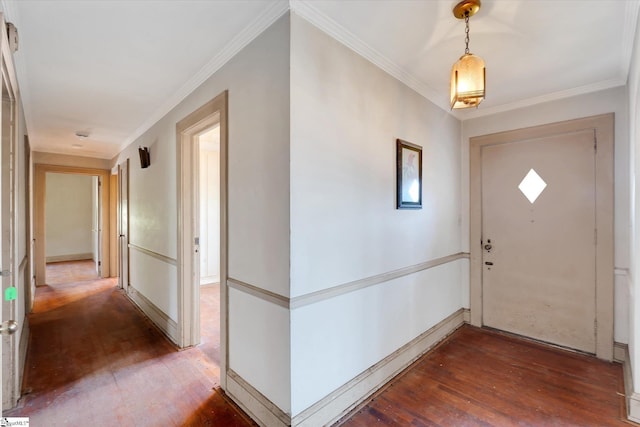 foyer entrance featuring baseboards, hardwood / wood-style floors, and crown molding