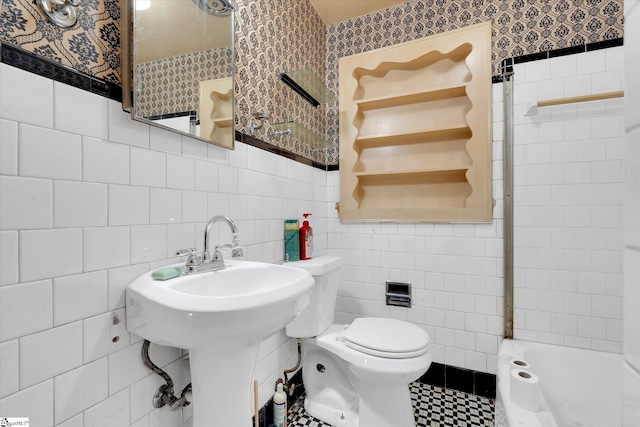 bathroom with tile patterned floors, tile walls, toilet, and walk in shower