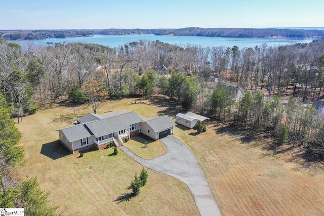 aerial view with a water view and a view of trees