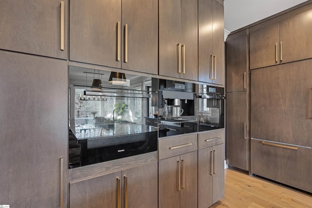 kitchen featuring dark countertops and light wood-style floors