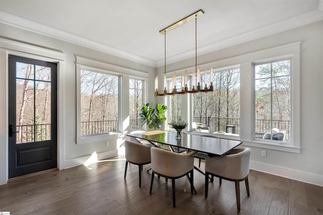 dining room with ornamental molding, dark wood-type flooring, and baseboards