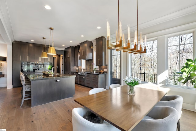 dining room featuring a chandelier, wood-type flooring, and recessed lighting