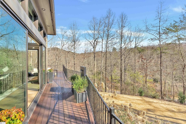 wooden deck featuring a wooded view