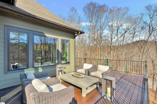 wooden terrace with an outdoor living space